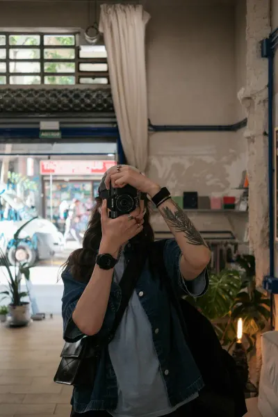 A traveller taking a photo with a film camera